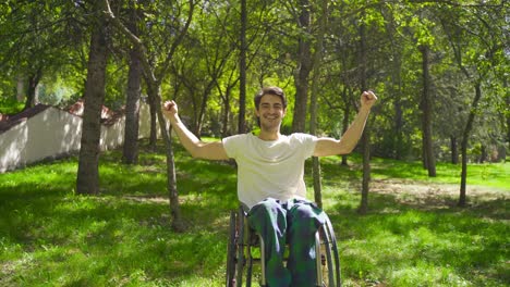 Physically-disabled-young-man-looks-at-camera,-rejoices-and-is-happy.